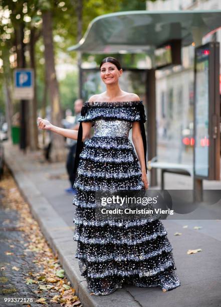 Giovanna Battaglia wearing off shoulder dress seen outside Valentino on day four during Paris Fashion Week Haute Couture FW18 on July 4, 2018 in...