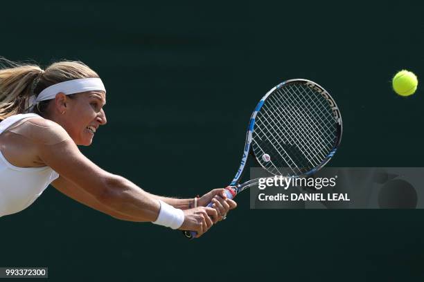 Slovakia's Dominika Cibulkova returns to Belgium's Elise Mertens in their women's singles third round match on the sixth day of the 2018 Wimbledon...