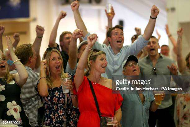 Racegoers celebrate Englands second goal against Sweden in the FIFA World Cup quarter final during Coral Eclipse day at Sandown Park Racecourse,...