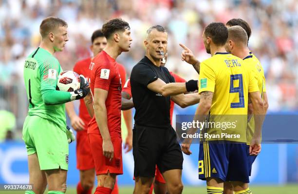 Referee Bjorn Kuipers separates Jordan Pickford of England and Marcus Berg of Sweden during the 2018 FIFA World Cup Russia Quarter Final match...