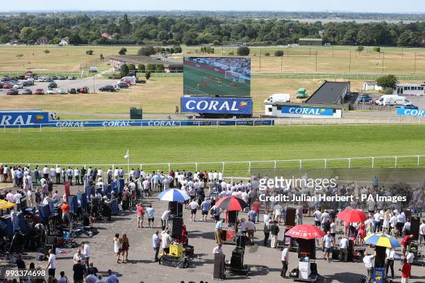 Racegoers watch the World Cup quarter final between England and Sweden during Coral Eclipse day at Sandown Park Racecourse, Esher.