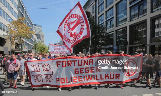 Ultras of Fortuna Duesseldorf march amongst other protesters to denounce a new law that would give police more powers on July 7, 2018 in Dusseldorf,...