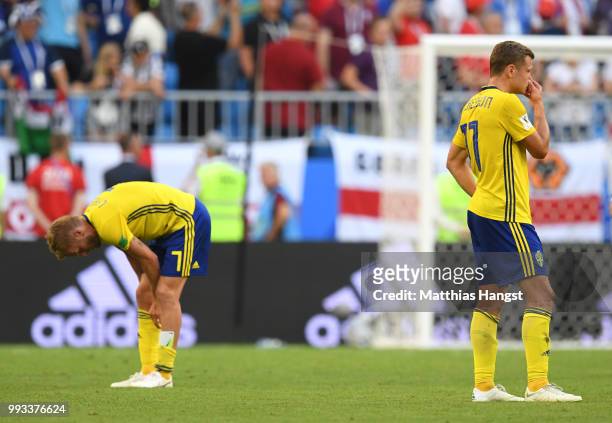 Sebastian Larsson and John Guidetti of Sweden show their dejection following the 2018 FIFA World Cup Russia Quarter Final match between Sweden and...