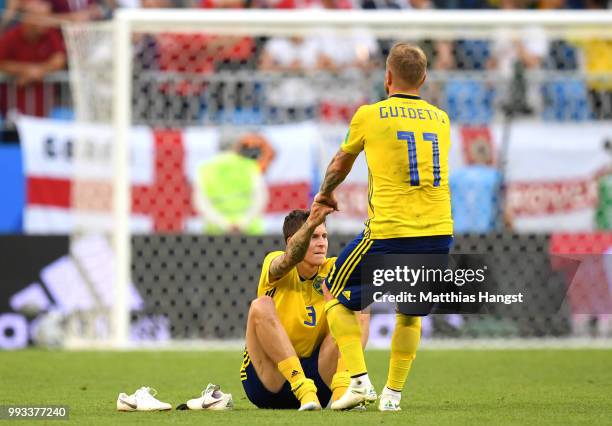 John Guidetti of Sweden consoles teammate Victor Lindelof of Sweden following their sides defeat in the 2018 FIFA World Cup Russia Quarter Final...