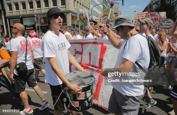 Ultras of Cologne march between other protesters to denounce a new law that would give police more powers on July 7, 2018 in Dusseldorf, Germany. The...