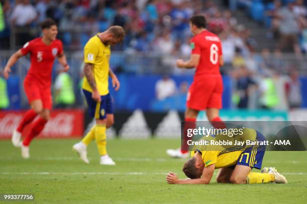 Viktor Claesson and John Guidetti of Sweden look dejected at the end of the 2018 FIFA World Cup Russia Quarter Final match between Sweden and England...