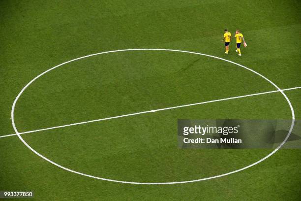 John Guidetti and Victor Lindelof of Sweden walk off the pitch dejected following the 2018 FIFA World Cup Russia Quarter Final match between Sweden...