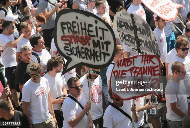 Ultras of Cologne march between other protesters to denounce a new law that would give police more powers on July 7, 2018 in Dusseldorf, Germany. The...