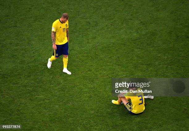 John Guidetti and Victor Lindelof of Sweden look dejected following the 2018 FIFA World Cup Russia Quarter Final match between Sweden and England at...