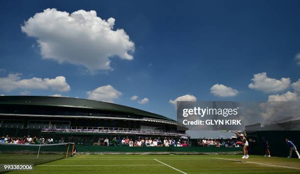 Australia's Daria Gavrilova serves against Belarus' Aliaksandra Sasnovich during their women's singles third round match on the sixth day of the 2018...