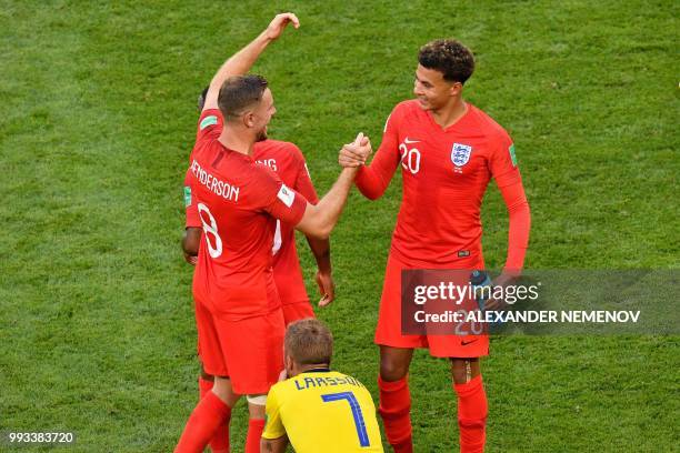 England's midfielder Jordan Henderson and England's midfielder Dele Alli celebrate after winning the Russia 2018 World Cup quarter-final football...