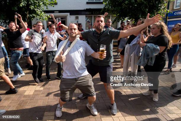 Football fans celebrate at the final whistle as England beat Sweden in the World Cup Quarter Finals outside The Lord Stamford public house on July 7,...