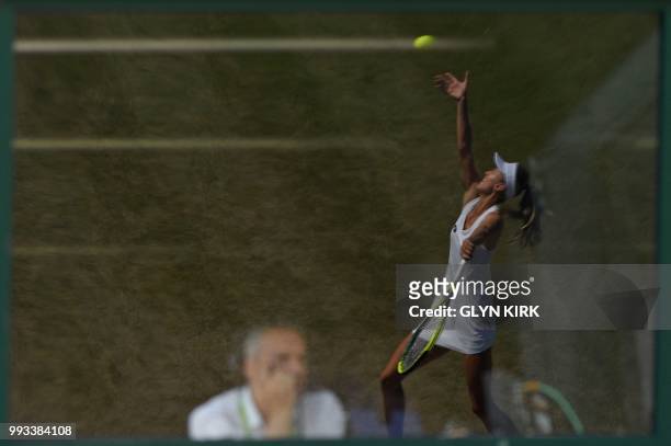 Belarus's Aliaksandra Sasnovich is reflected in the window of a commentary box as she serves against Australia's Daria Gavrilova during their women's...