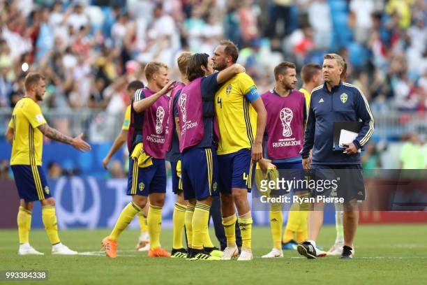 Gustav Svensson of Sweden consoles teammate Andreas Granqvist following their sides defeat in the 2018 FIFA World Cup Russia Quarter Final match...