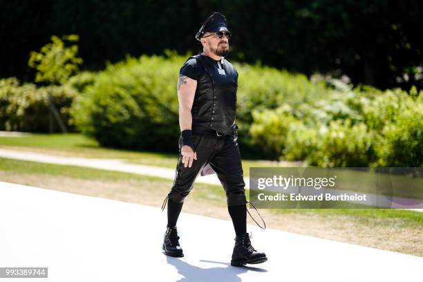 Peter Marino wears a black hat, a black t-shirt, a black leather and studded sleeveless jacket, sunglasses , outside Dior, during Paris Fashion Week...