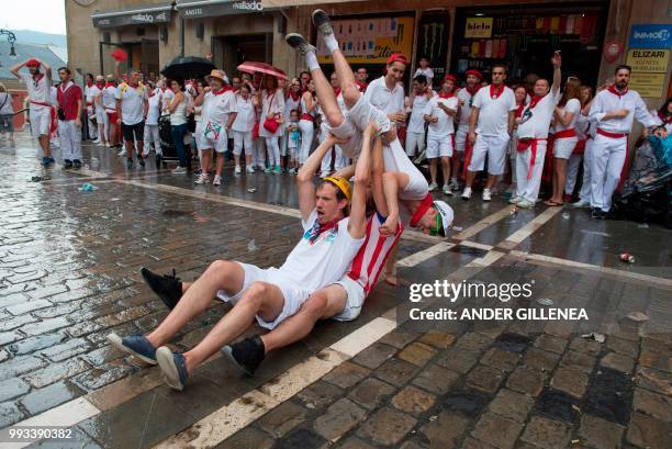 Revellers enjoy festvities on the first day of the San Fermin bull run festival in Pamplona, northern Spain on July 7, 2018. - Each day at 8am...