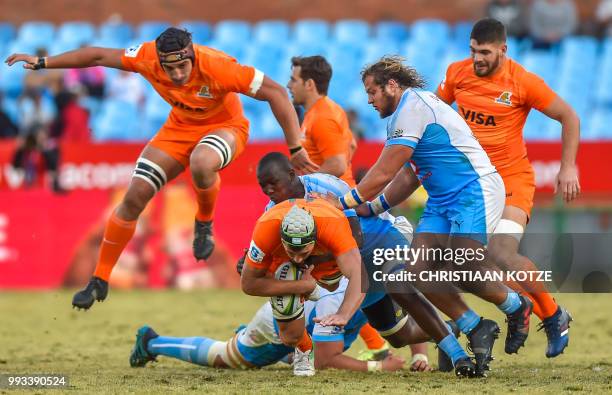 Argentina's Jaguares lock Guido Petti is tackled by South Africa's Bulls Thembelani Bholi during the Super Rugby match between Bulls and Jaguares at...