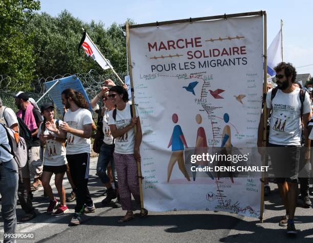 People take part in a "solidarity" march in support of migrants in Calais on July 7, 2018. - Several hundred people took part in the march, organised...