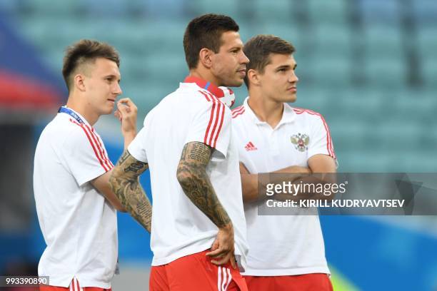 Russia's midfielder Aleksandr Golovin, forward Fedor Smolov and midfielder Roman Zobnin inspect the pitch before the Russia 2018 World Cup...