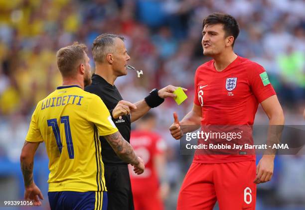 Referee Bjorn Kuipers separates John Guidetti of Sweden and Harry Maguire of England during the 2018 FIFA World Cup Russia Quarter Final match...