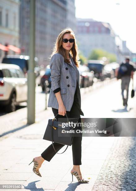 Alexandra Lapp wearing Cool Ambition Semi Loose Fit Pants in black from Dorothee Schumacher with a high waist, white strong statement shirt saying...