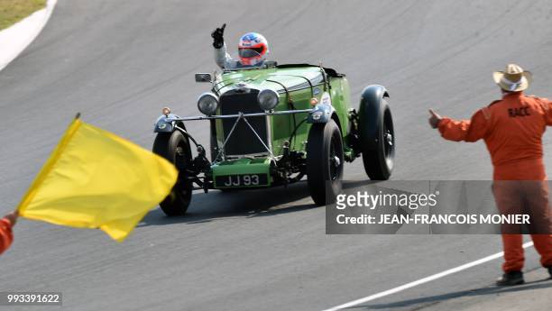 British driver Gareth Burnett in his Talbot 105 JJ93-1932, reacts after winning a race for vehicles from 1923 to 1939, during the ninth edition of Le...