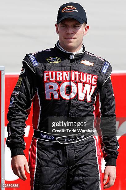 Regan Smith, driver of the Furniture Row Racing Chevrolet, walks on the grid during qualifying for the NASCAR Sprint Cup Series Autism Speaks 400 at...