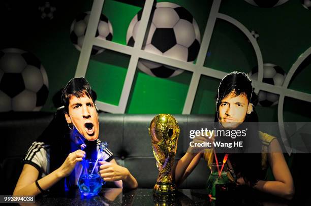 Two Models pose in Messi of Argentina and Neymar of Brazil masks at KTV on June 28, 2014 in Wuhan, Hubei Province, China. Millions of people watched...