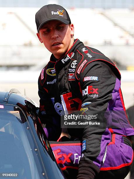 Denny Hamlin, driver of the FedEx Freight Toyota, gets out of his car after qualifying for the NASCAR Sprint Cup Series Autism Speaks 400 at Dover...