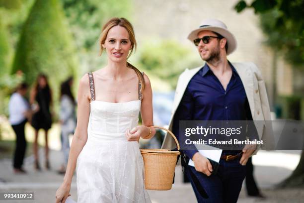 Lauren Santo Domingo wears a white dress from Dior , outside Dior, during Paris Fashion Week Haute Couture Fall Winter 2018/2019, on July 2, 2018 in...