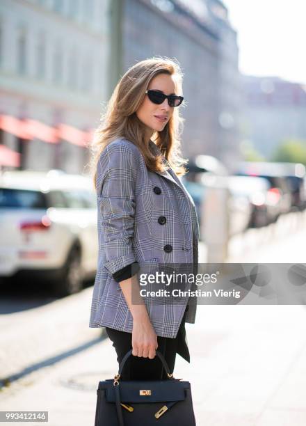 Alexandra Lapp wearing Cool Ambition Semi Loose Fit Pants in black from Dorothee Schumacher with a high waist, white strong statement shirt saying...