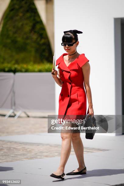 Leaf Greener, fashion blogger, wears a red dress , outside Dior, during Paris Fashion Week Haute Couture Fall Winter 2018/2019, on July 2, 2018 in...