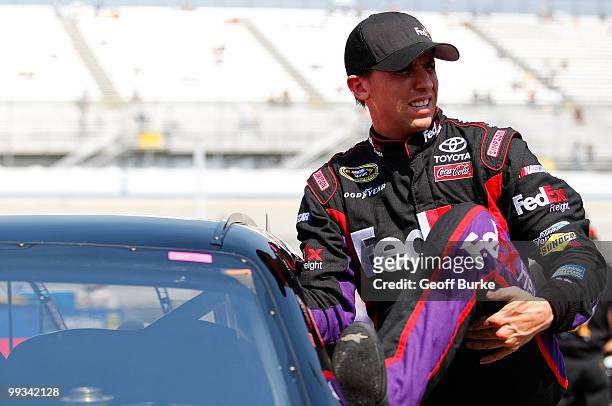 Denny Hamlin, driver of the FedEx Freight Toyota, gets out of his car after qualifying for the NASCAR Sprint Cup Series Autism Speaks 400 at Dover...