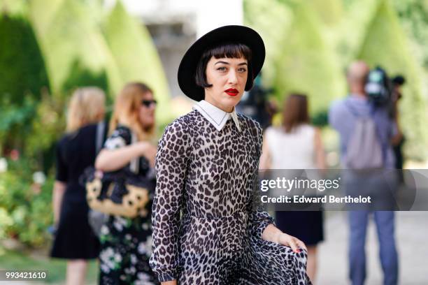 Mia Moretti wears a hat, a leopard print dress, black Lady Dior bag , outside Dior, during Paris Fashion Week Haute Couture Fall Winter 2018/2019, on...