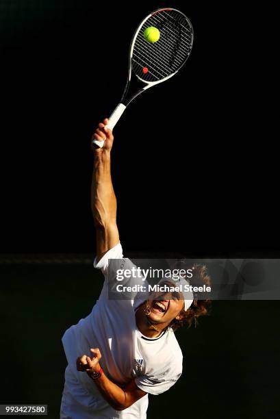 Alexander Zverev of Germany serves against Ernests Gulbis of Latvia during their Men's Singles third round match on day six of the Wimbledon Lawn...
