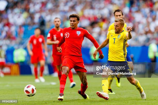 Dele Alli of England battle for the ball with Sebastian Larsson of Sweden during the 2018 FIFA World Cup Russia Quarter Final match between Sweden...