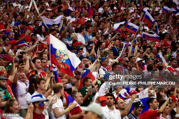 Russia fans cheer before the Russia 2018 World Cup quarter-final football match between Russia and Croatia at the Fisht Stadium in Sochi on July 7,...