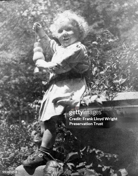 Llewellyn Wright perched on front porch urn, at the Frank Lloyd Wright Home and Studio, located at 951 Chicago Avenue, Oak Park, Illinois, 1905.