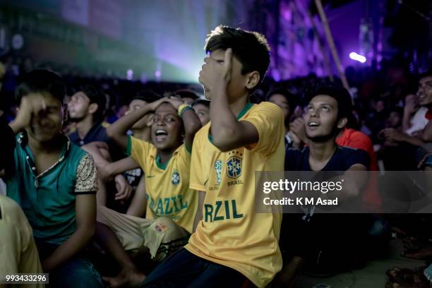 Bangladeshi football fan react when he watching the Russia 2018 World Cup football matches between Brazil and Belgium on a big screen in Dhaka.