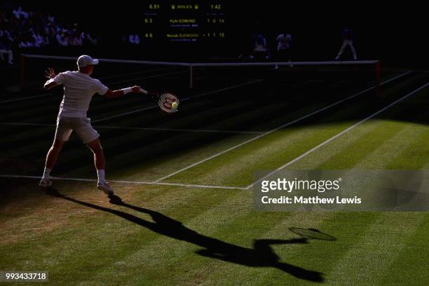 Kyle Edmund of Great Britain returns a shot against Novak Djokovic of Serbia during their Men's Singles third round match on day six of the Wimbledon...