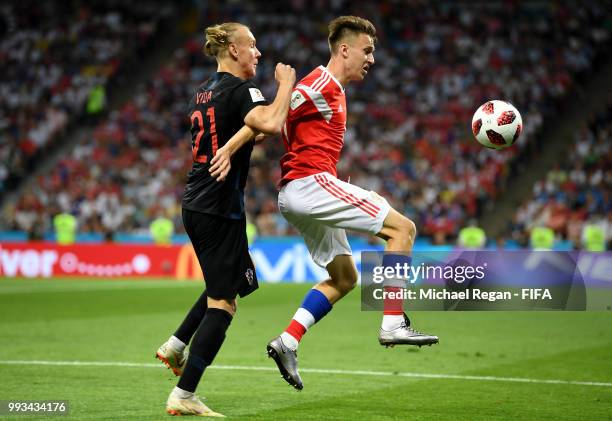 Aleksandr Golovin of Russia is challenged by Domagoj Vida of Croatia during the 2018 FIFA World Cup Russia Quarter Final match between Russia and...