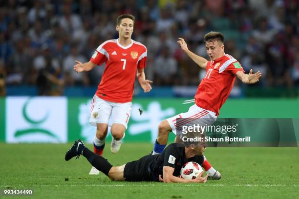 Ivan Strinic of Croatia is tackled by Aleksandr Golovin of Russia during the 2018 FIFA World Cup Russia Quarter Final match between Russia and...