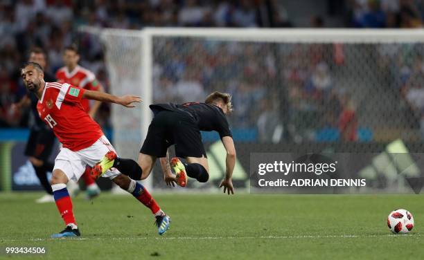 Croatia's midfielder Ivan Rakitic is fouled by Russia's midfielder Alexander Samedov during the Russia 2018 World Cup quarter-final football match...