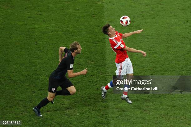 Ivan Strinic of Croatia challenges Aleksandr Golovin of Russia during the 2018 FIFA World Cup Russia Quarter Final match between Russia and Croatia...