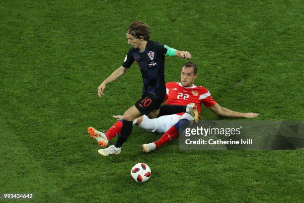Artem Dzyuba of Russia tackles Luka Modric of Croatia during the 2018 FIFA World Cup Russia Quarter Final match between Russia and Croatia at Fisht...