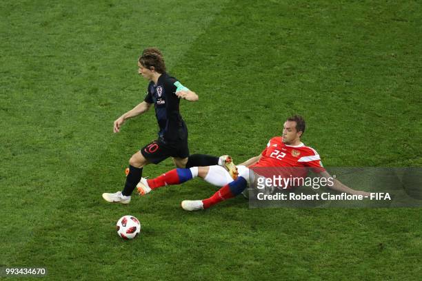 Artem Dzyuba of Russia tackles Luka Modric of Croatia during the 2018 FIFA World Cup Russia Quarter Final match between Russia and Croatia at Fisht...