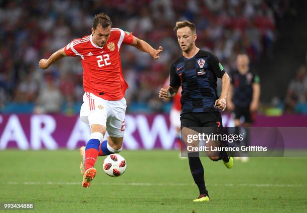 Artem Dzyuba of Russia is challenged by Ivan Rakitic of Croatia during the 2018 FIFA World Cup Russia Quarter Final match between Russia and Croatia...