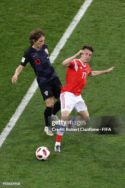 Aleksandr Golovin of Russia tackles Luka Modric of Croatia during the 2018 FIFA World Cup Russia Quarter Final match between Russia and Croatia at...