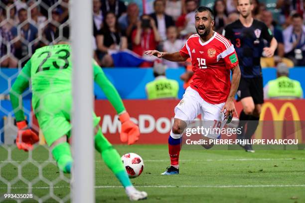 Russia's midfielder Alexander Samedov reacts as his shot on goal is saved by Croatia's goalkeeper Danijel Subasic during the Russia 2018 World Cup...