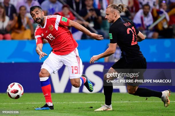 Russia's midfielder Alexander Samedov challenges Croatia's defender Domagoj Vida during the Russia 2018 World Cup quarter-final football match...